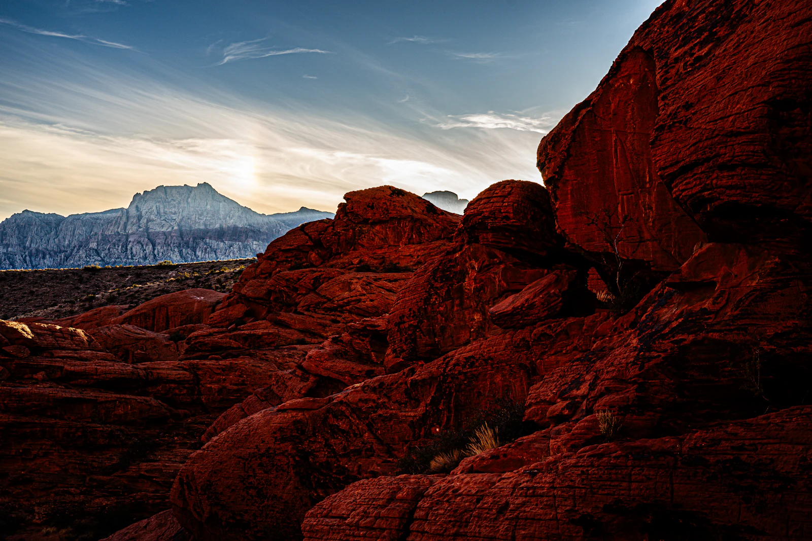 Red rock formations under a wide desert sky.