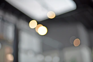 Photorealistic blurred shopping mall background with soft bokeh lights, evoking a calm shopping mood.