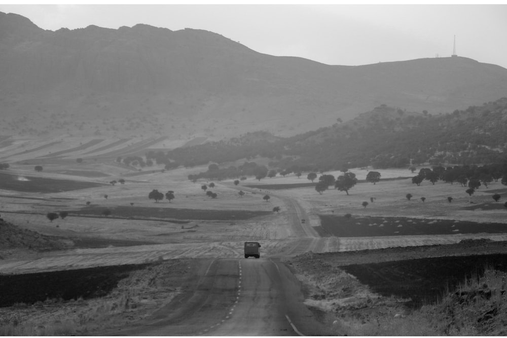 a black and white photo of a rural road