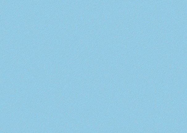 A simple, uniformly textured background with a light blue color.