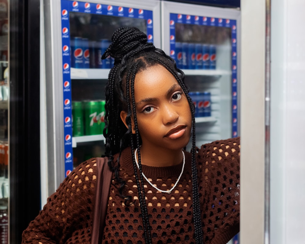 a woman standing in front of a vending machine