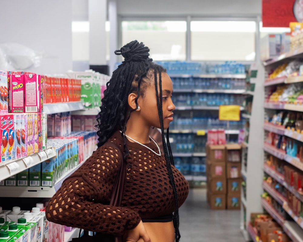 a woman with dreadlocks standing in a store aisle