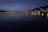 A charming night view of Lake Zurich with city lights reflecting on the water.