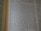 An open book displaying text with clear black font on a cream-colored page. The text is formatted in two columns, and the focus is on the central text, with parts slightly blurred on the edges.