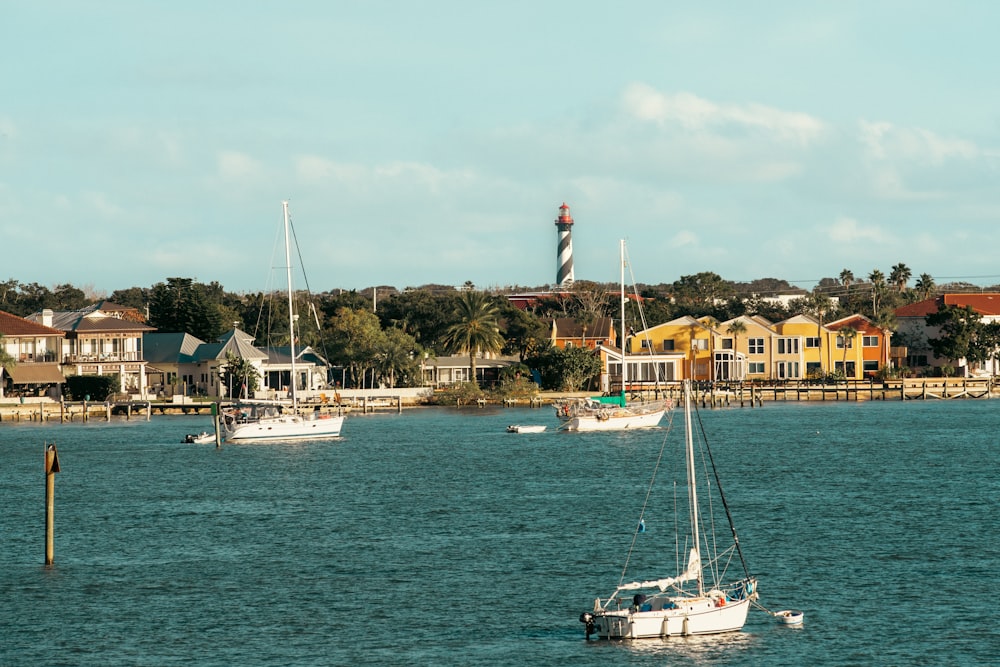 a couple of boats floating on top of a body of water