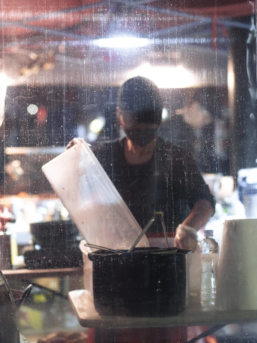 A chef cooking on a busy restaurant stove