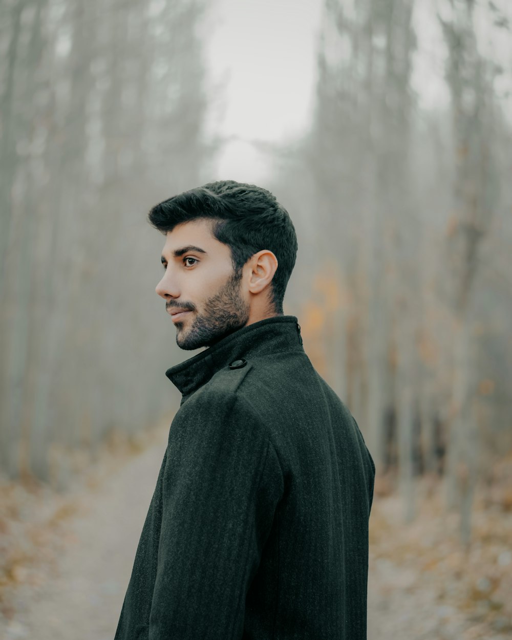 a man standing in the middle of a forest