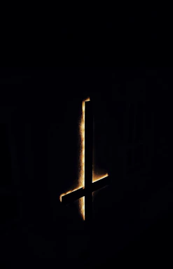 A mystical dark rune glowing softly against a shadowy background, evoking the spirit of Dark Saga.