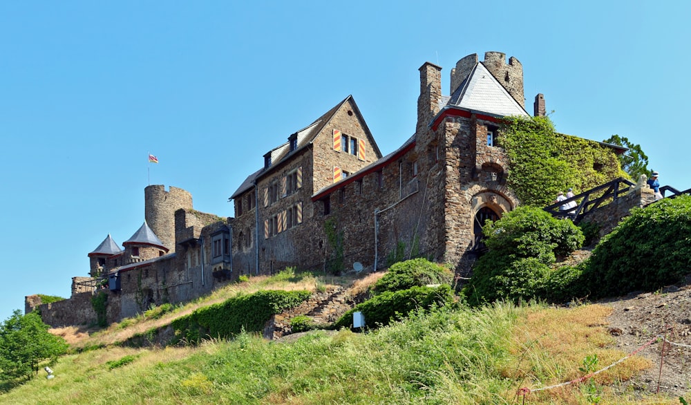 a castle on a hill with a sky background