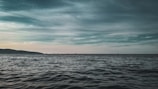 A calming seascape with gentle waves and a distant horizon.