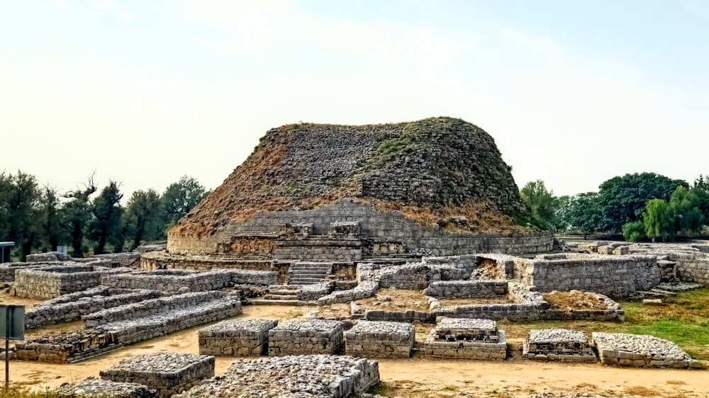 a large stone structure in the middle of a field