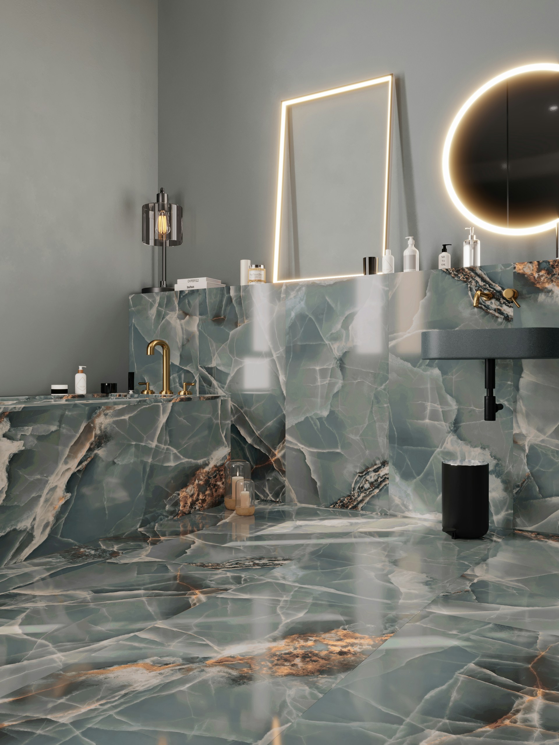 A modern bathroom features luxurious green and white marble surfaces throughout, including the walls, countertop, and floor. There is a rectangular mirror with a soft glow of LED lighting surrounding it and a circular mirror emits a warm ambient light. The gold fixtures, including a faucet, add an elegant touch. Various bottles and toiletries are neatly arranged on the countertop. The overall design is sleek and sophisticated.