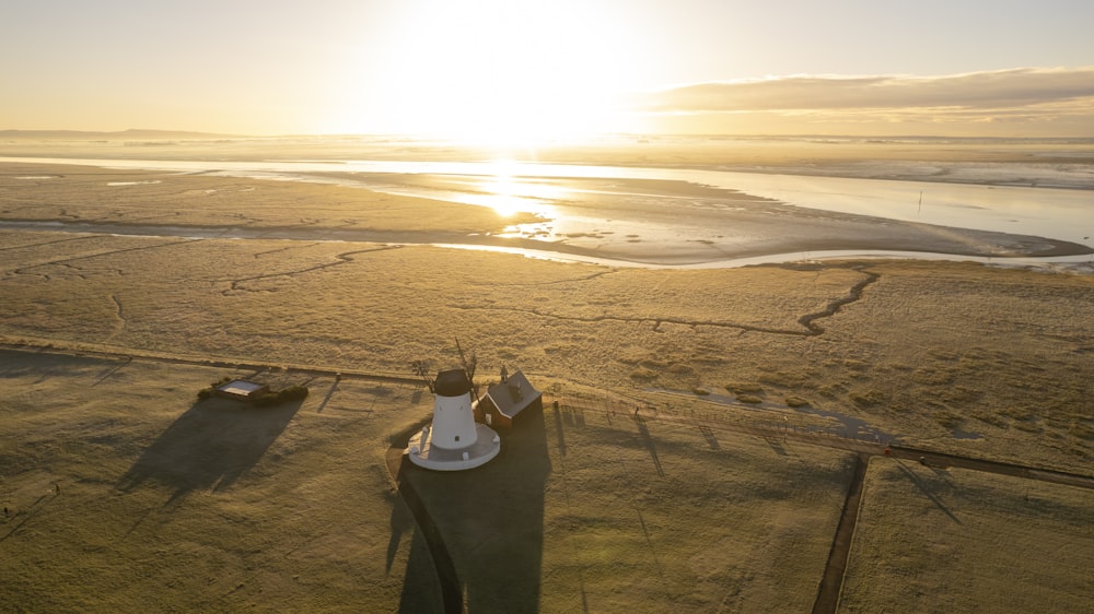 an aerial view of a farm with a sunset in the background