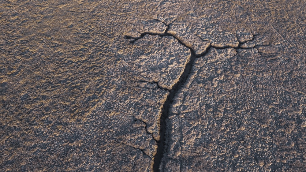 a crack in the ground in the middle of the desert
