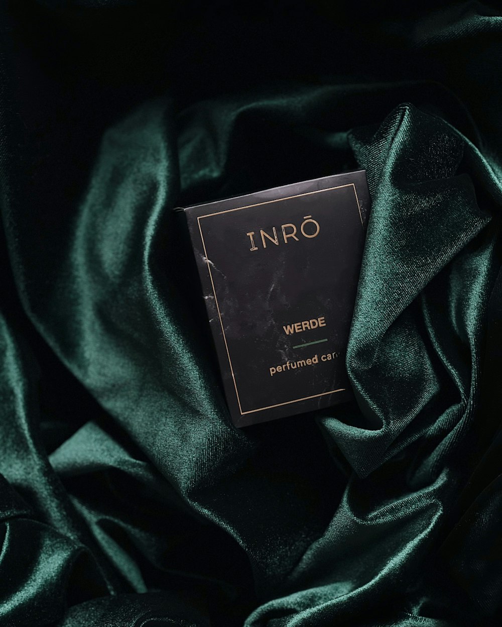 a book sitting on top of a green cloth