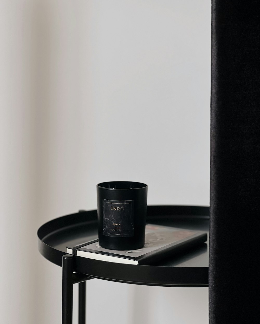 a black candle sitting on top of a table