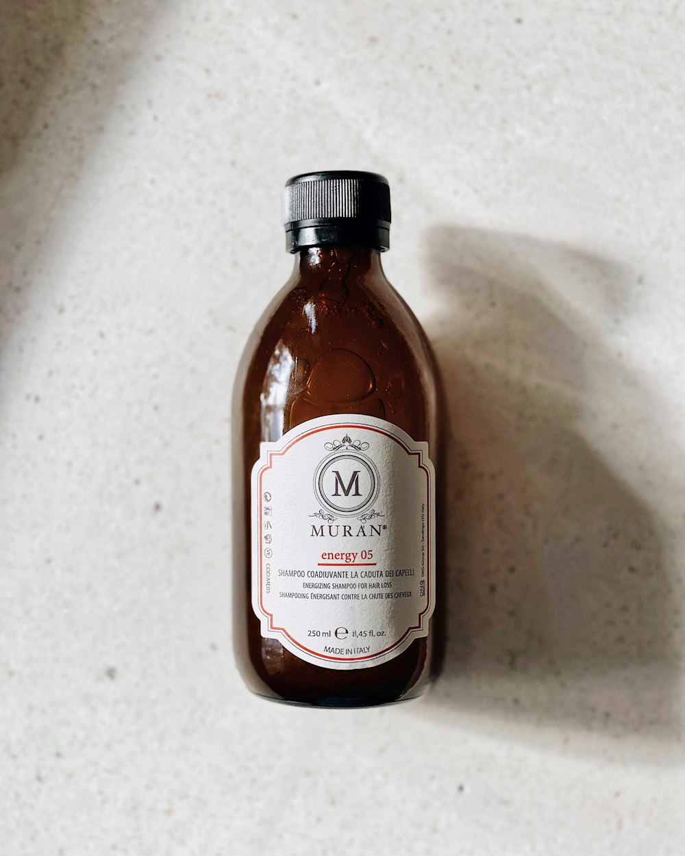 a bottle of liquid sitting on top of a white counter