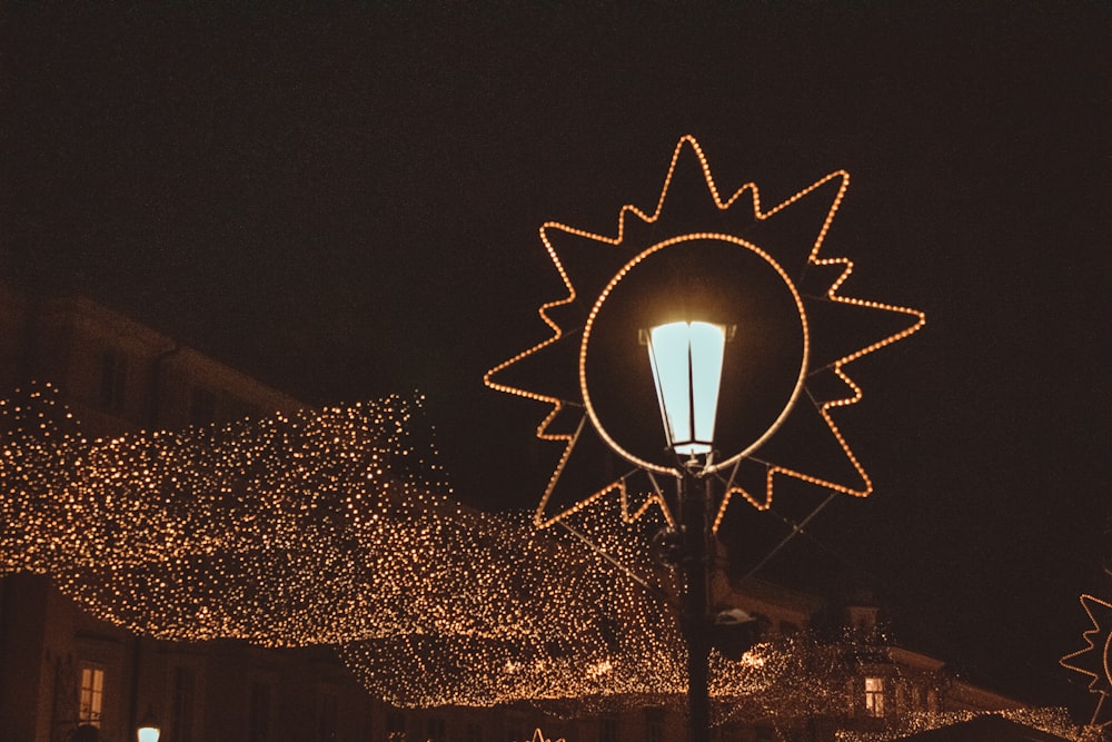 a street light is lit up with christmas lights