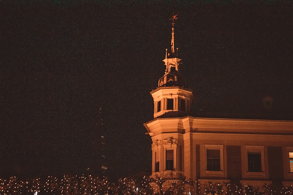 a building with a clock tower lit up at night