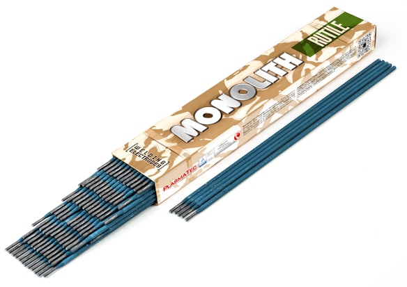 A box of welding electrodes labeled 'MONOLITH' in bold letters. The box has a camouflage pattern and the words 'Welding Electrodes' are clearly visible. Several blue welding rods are partially out of the box and also aligned beside it.