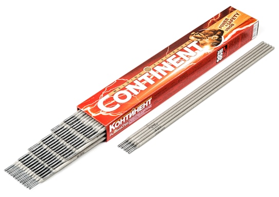 A red and orange box with the text 'CONTINENT' contains an array of gray welding electrodes. The box features a graphic of a person welding, with sparks visible. The electrodes are laid out neatly beside the box.