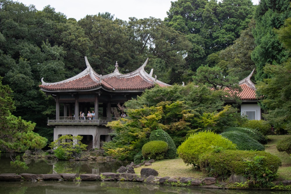 a small building in the middle of a pond