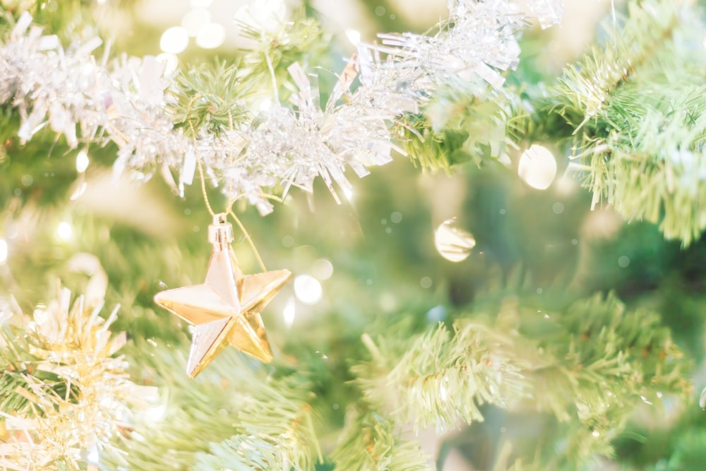 a star ornament hanging from a christmas tree