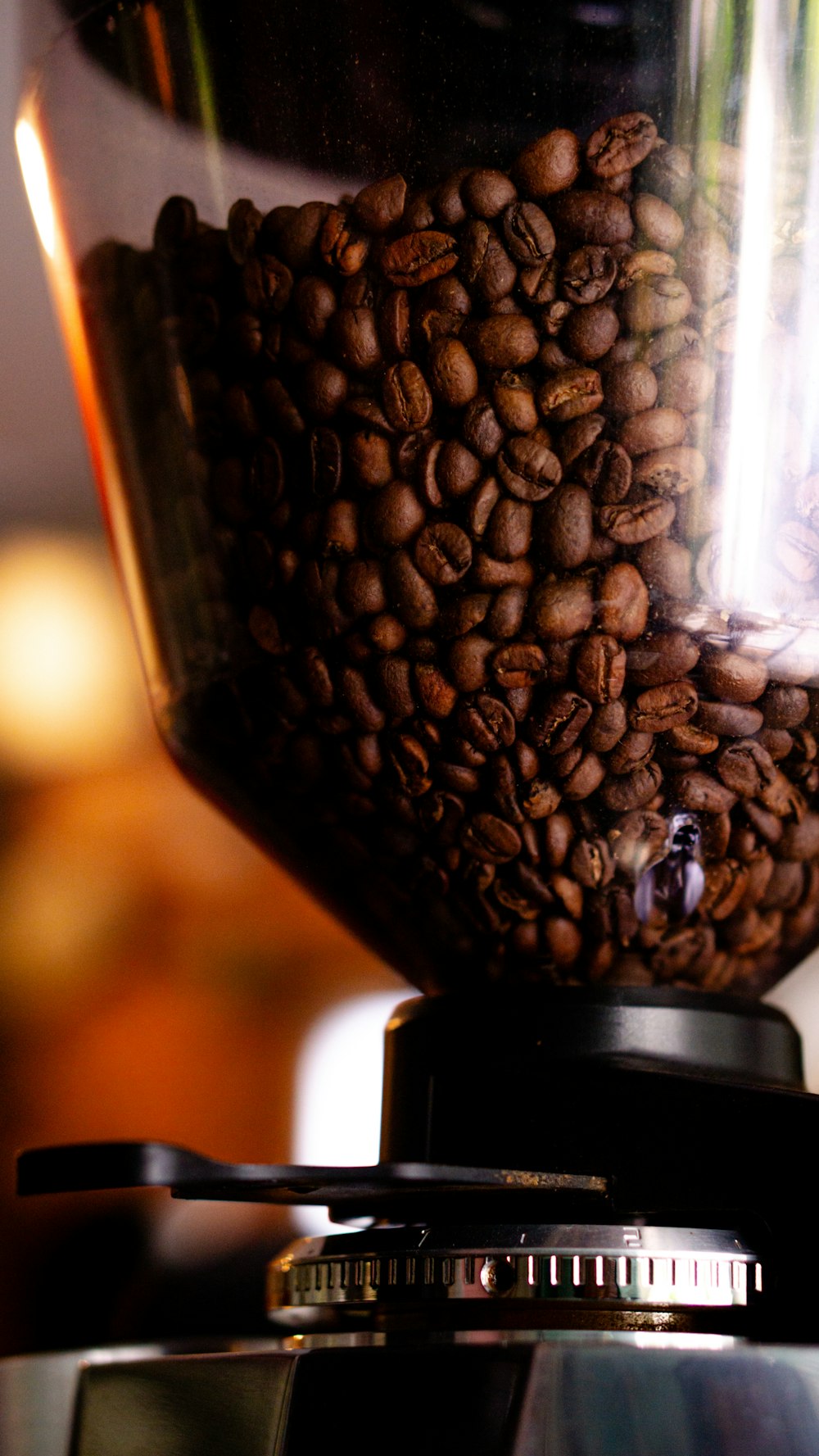 a coffee grinder filled with lots of coffee beans