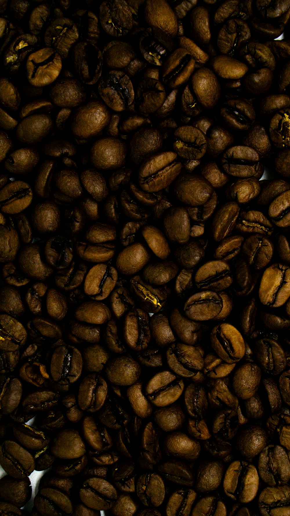 a pile of coffee beans sitting on top of each other