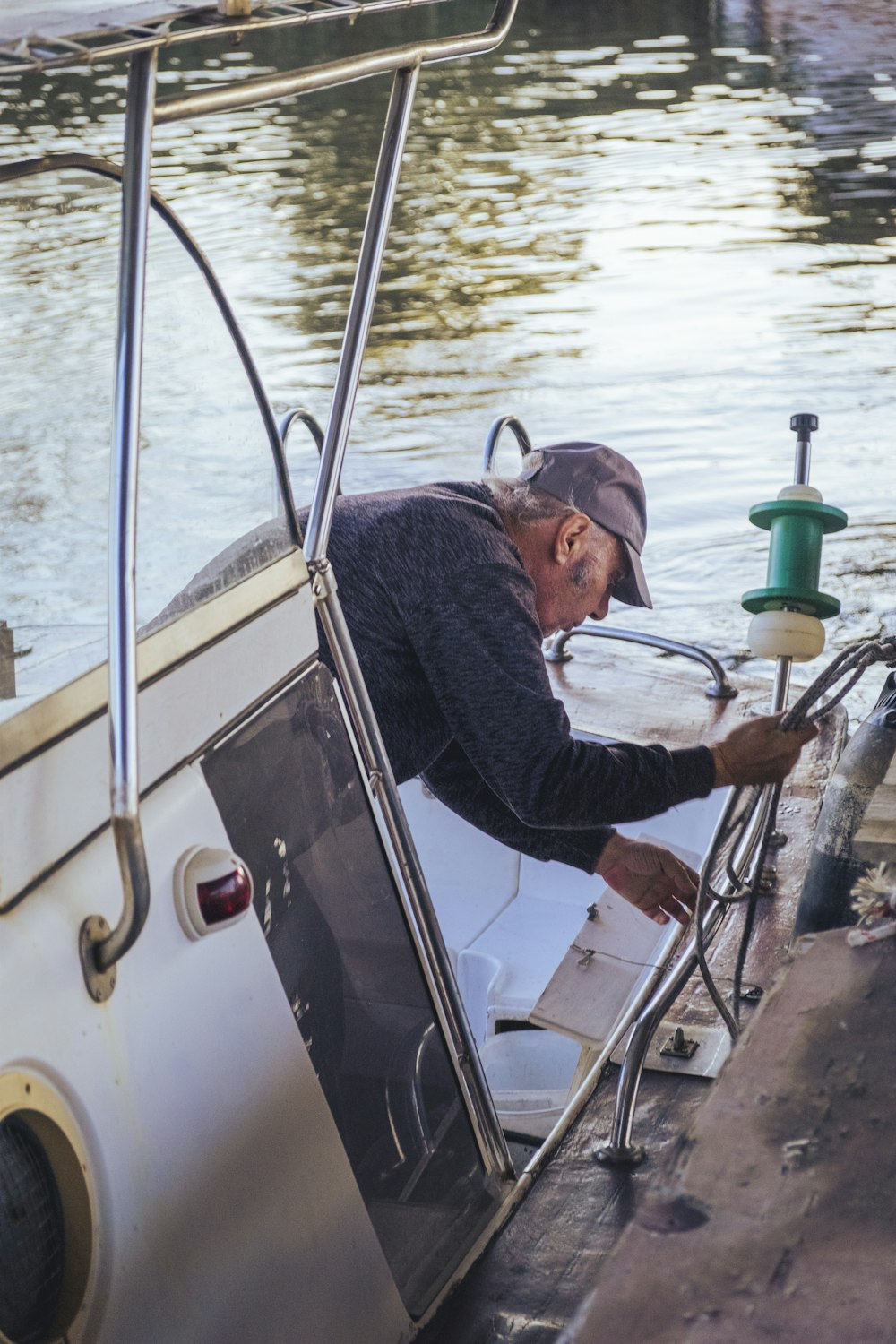 a man sitting on a boat in the water