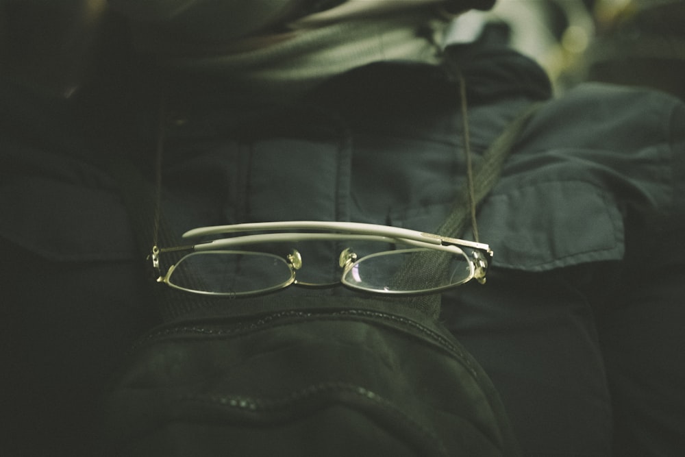 a pair of glasses sitting on top of a backpack