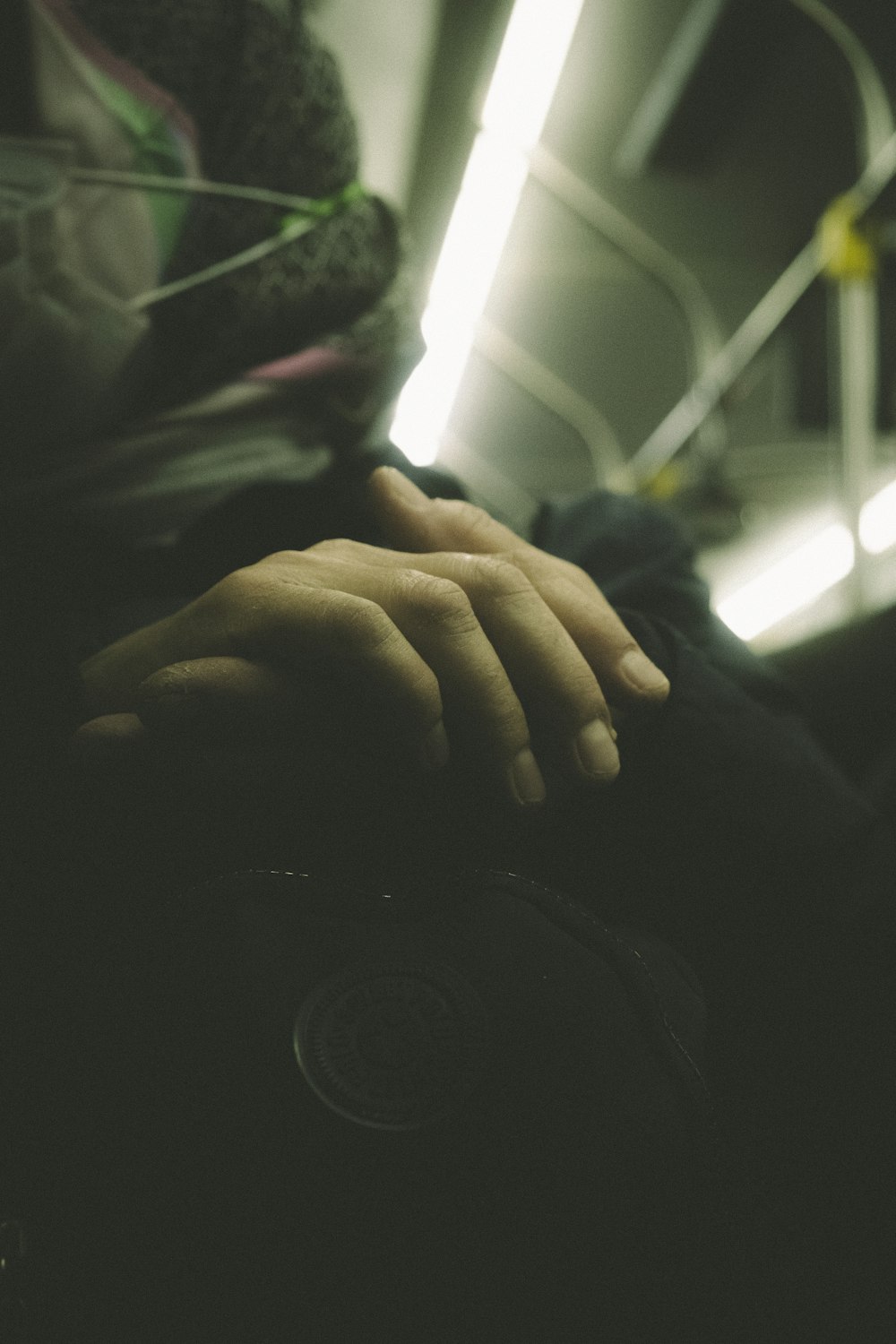 a person's hand resting on the seat of a bus