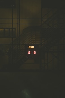a clock that is on a building in the dark