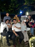 A group of friends laughing and dancing together at night.
