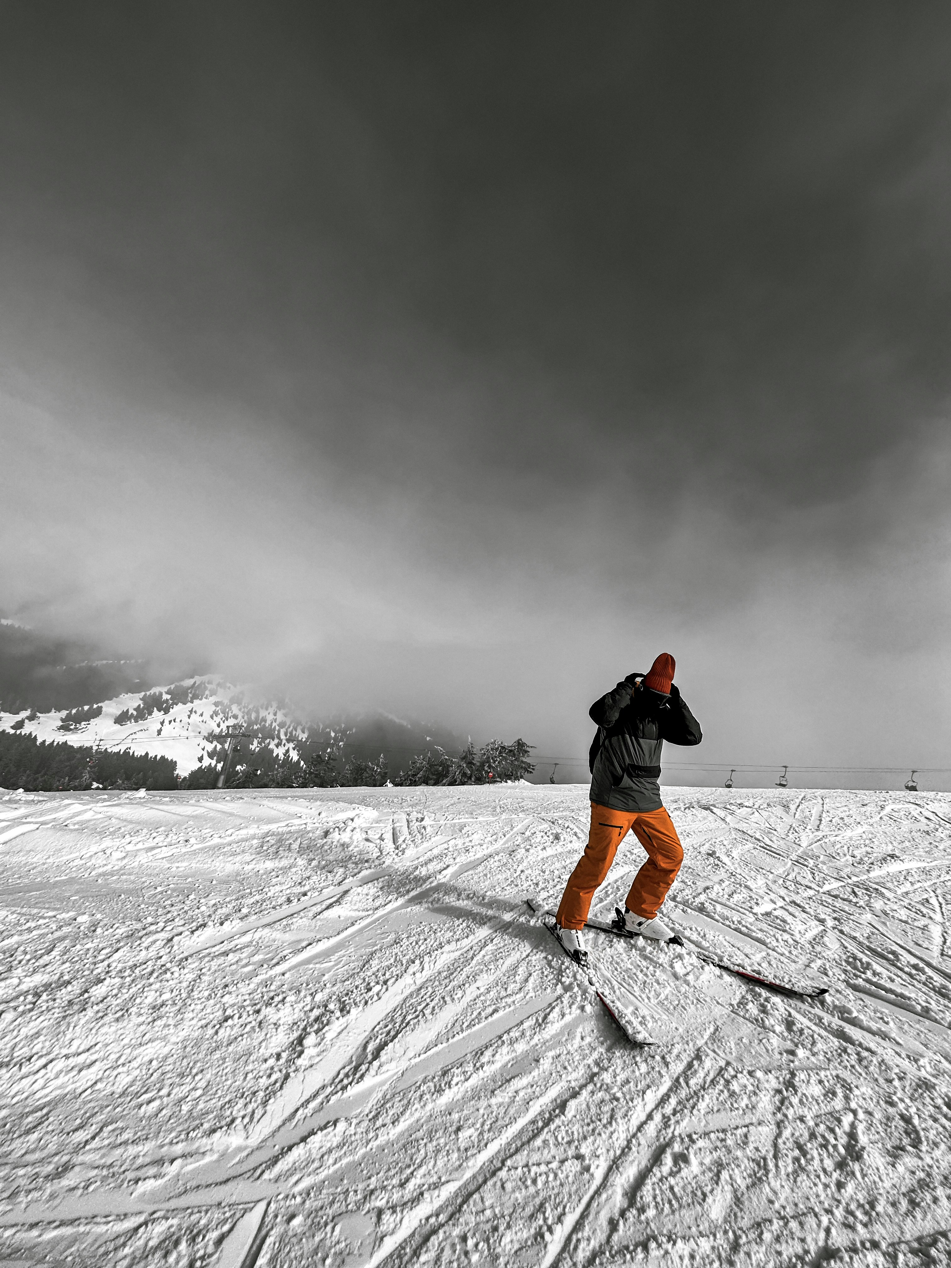 a man riding skis down a snow covered slope