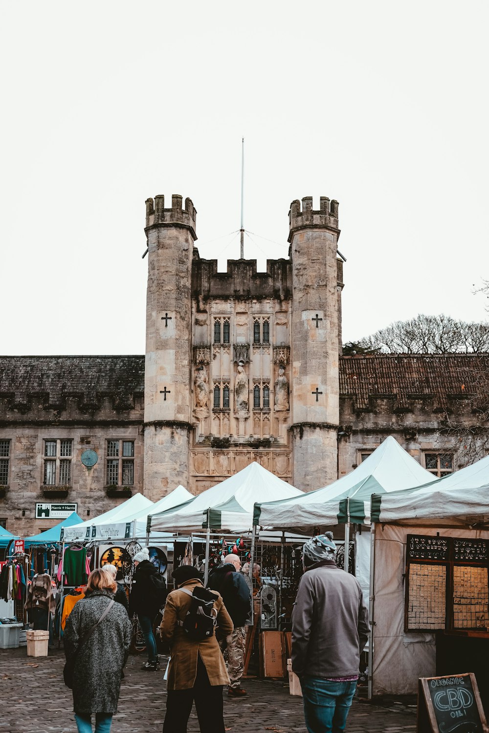 a group of people walking around a market