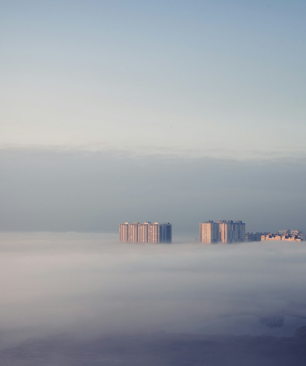 a city in the middle of a foggy sky
