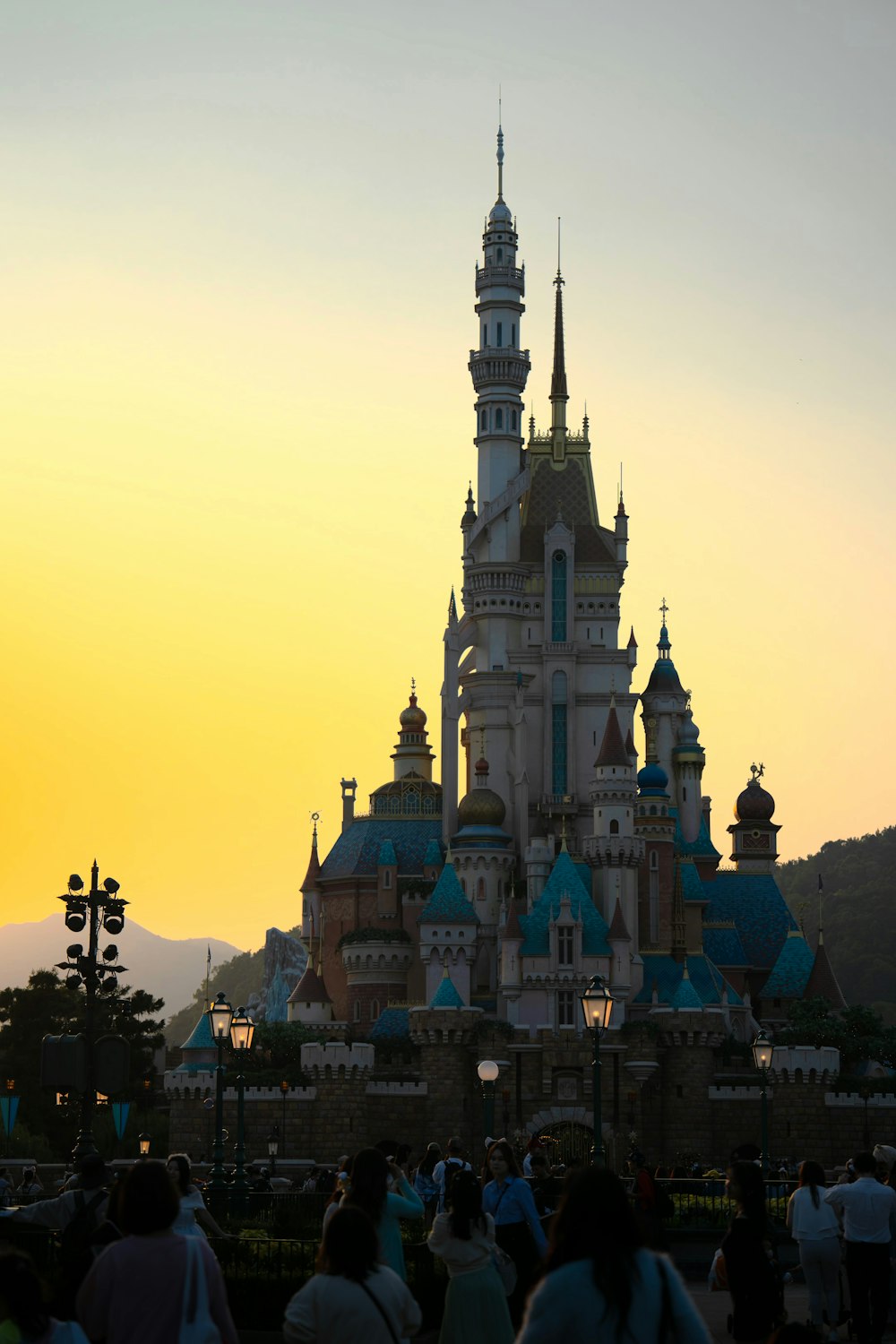 a crowd of people standing in front of a castle