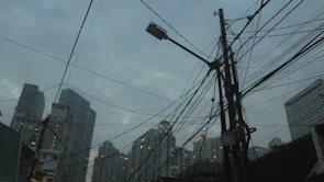 Electrician inspecting wiring with the UAE skyline in the background.