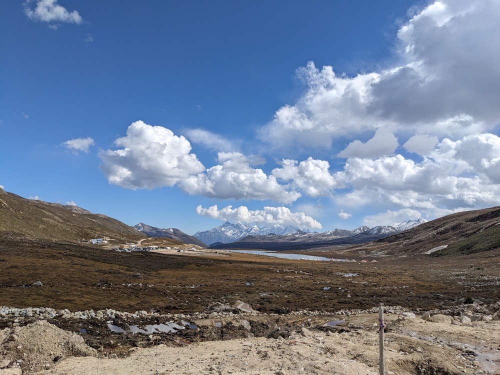 a view of a mountain range with a lake in the distance