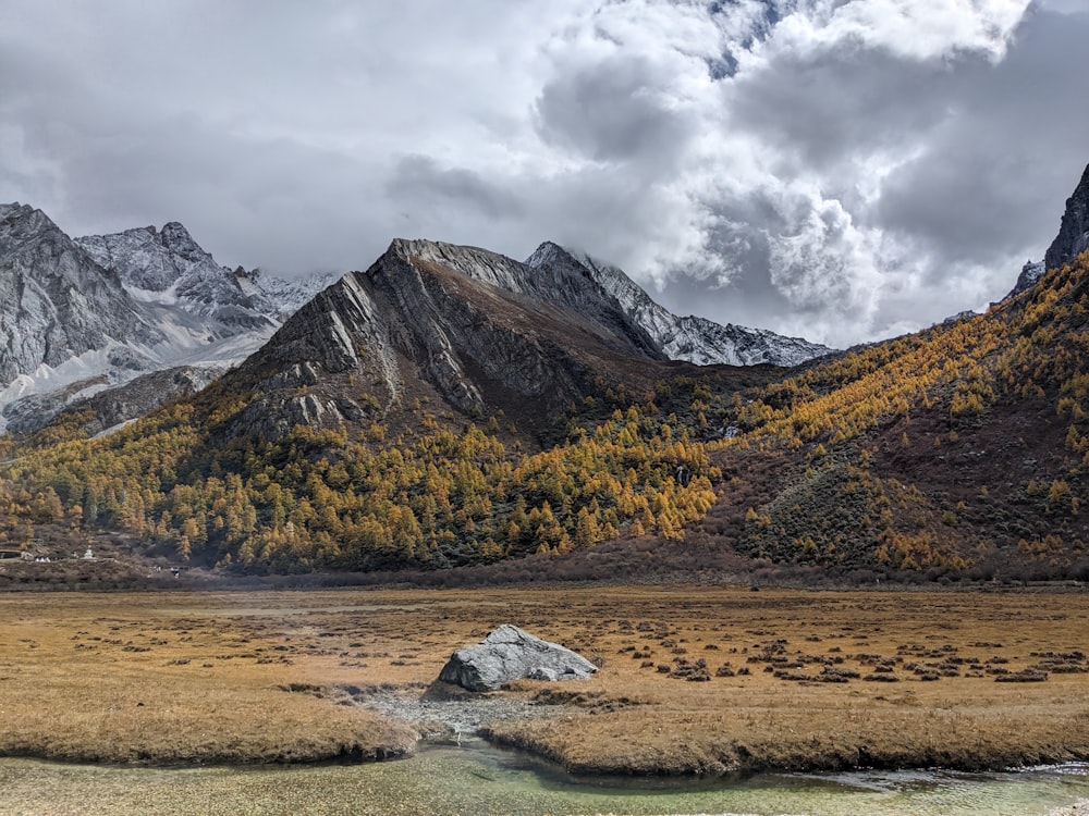 a mountain range with a river in the foreground