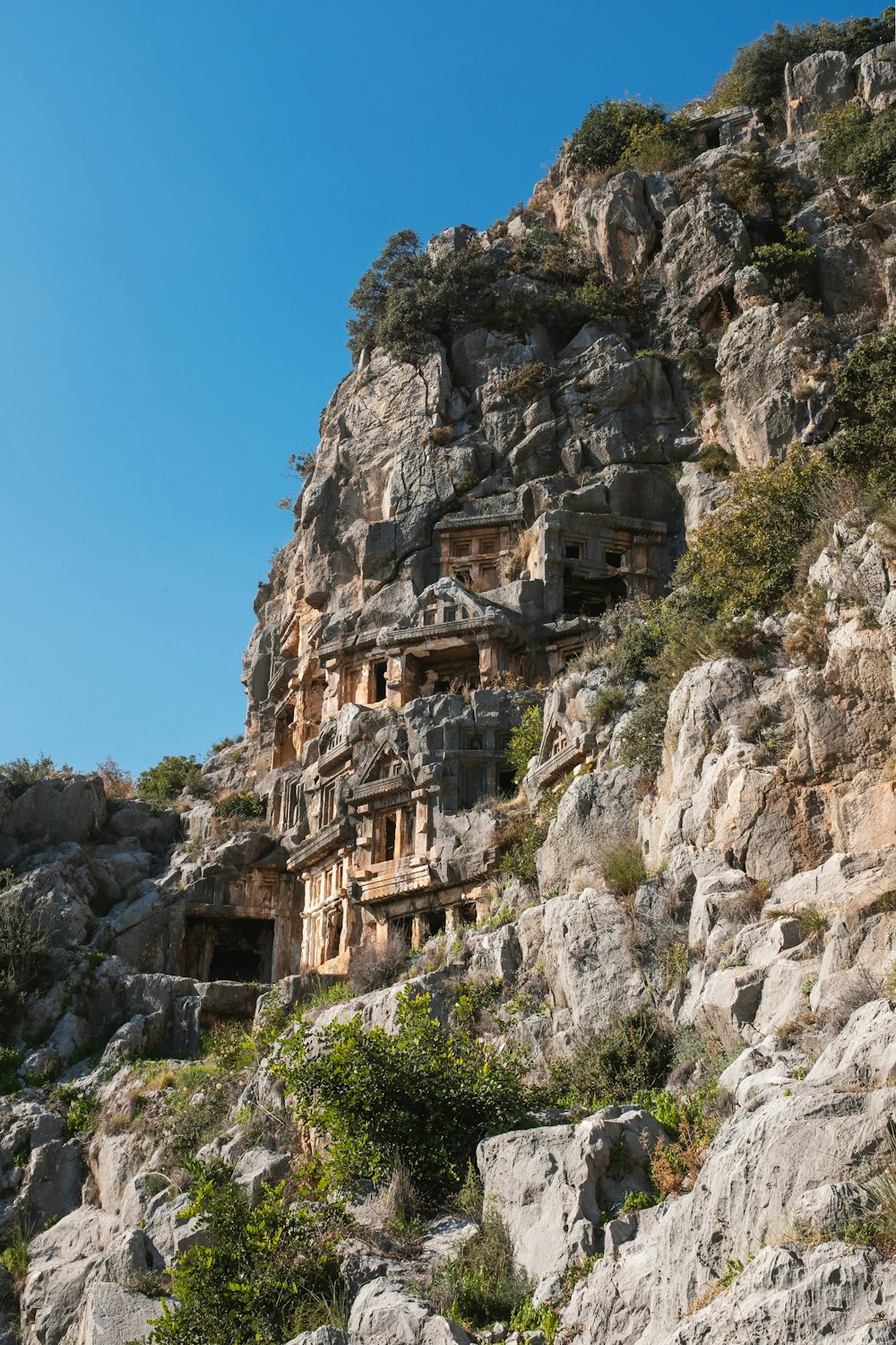 a rocky cliff with a cave like structure built into the side of it