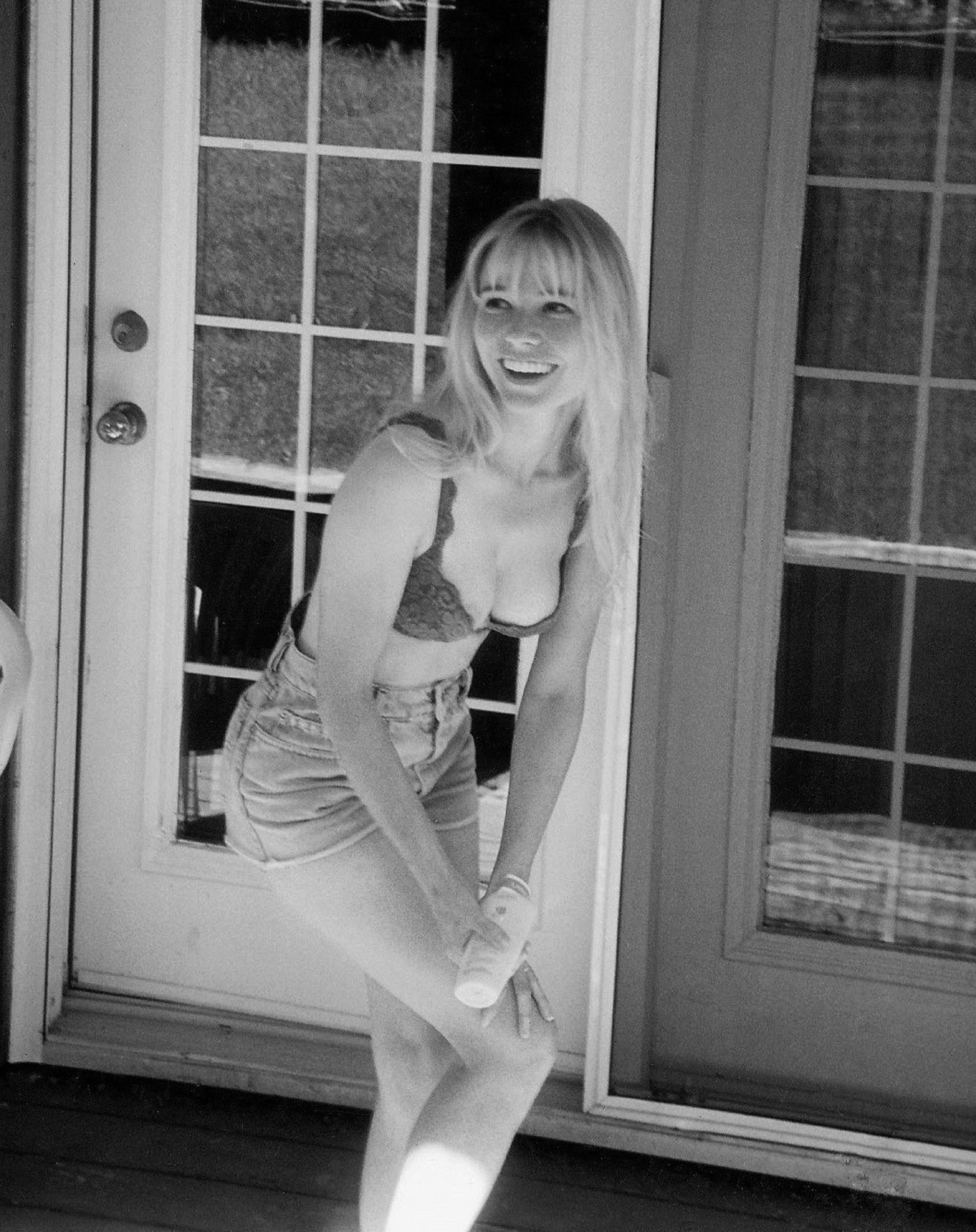 a woman in a bathing suit standing in front of a door