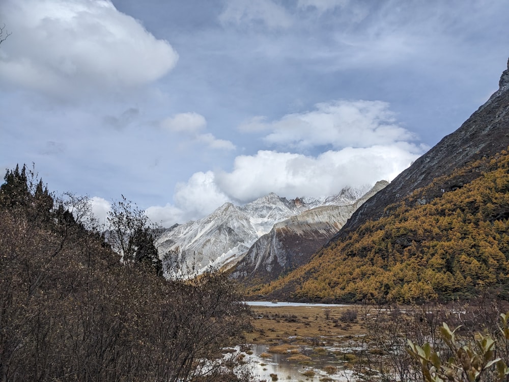 a view of a mountain range with a lake in the foreground