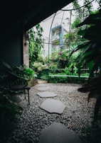 A serene landscaped garden with lush greenery and stone pathways.