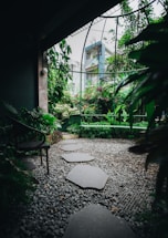 A serene garden with lush greenery and a tranquil pathway.