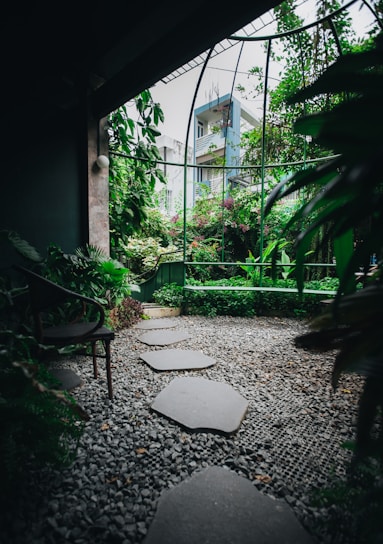 A serene garden with lush greenery and a tranquil pathway.