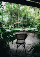 An elegant garden space featuring lush greenery and seating.