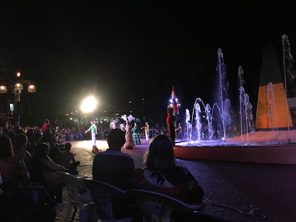 A lively crowd enjoying traditional dance performances at Visakha Utsav under colorful festival lights.