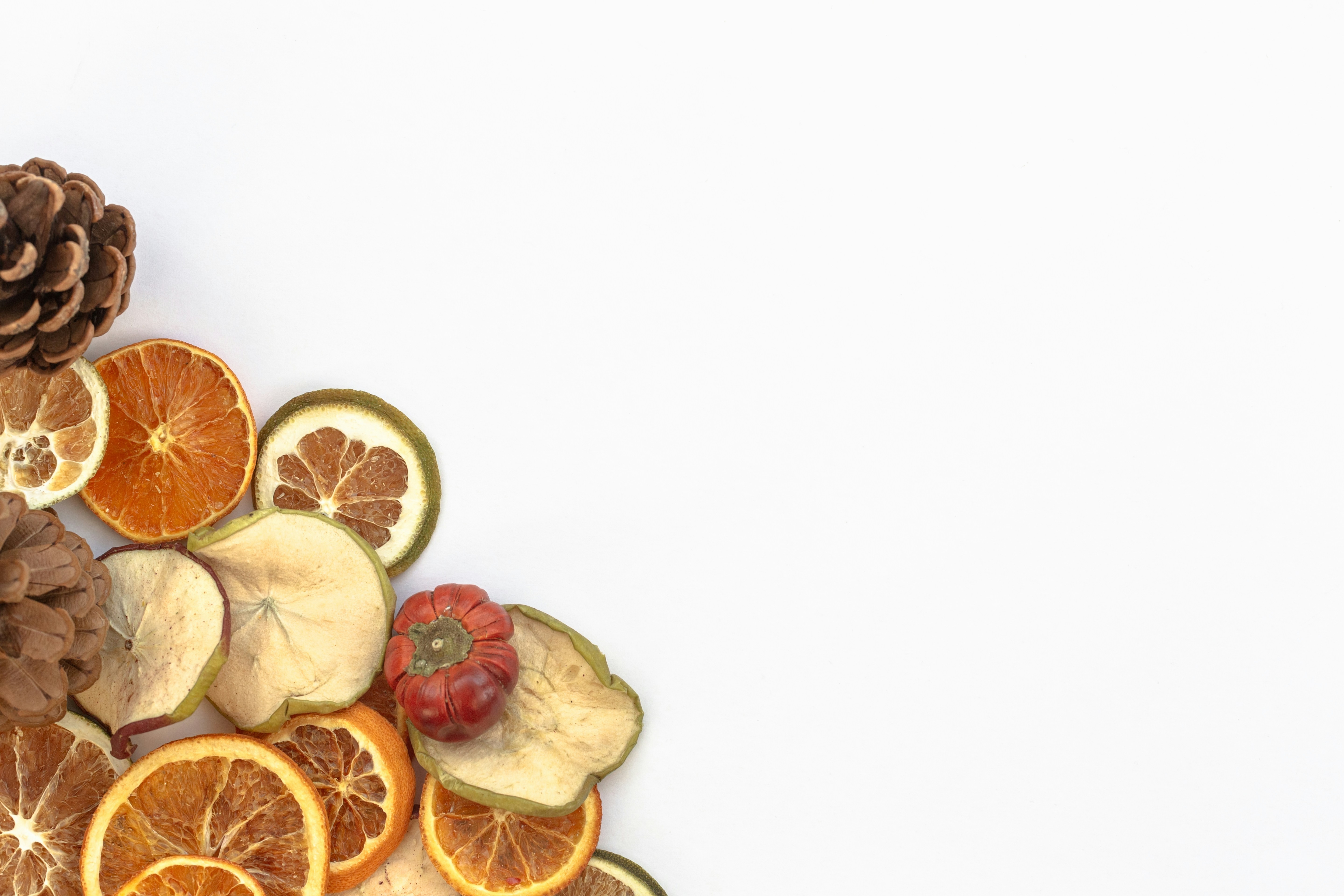 a pile of sliced oranges and pine cones